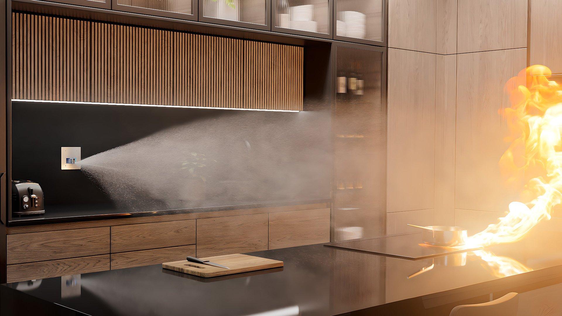 In a modern kitchen, an Automist wall sprinkler sprays water at a saucepan burning on an island stovetop.